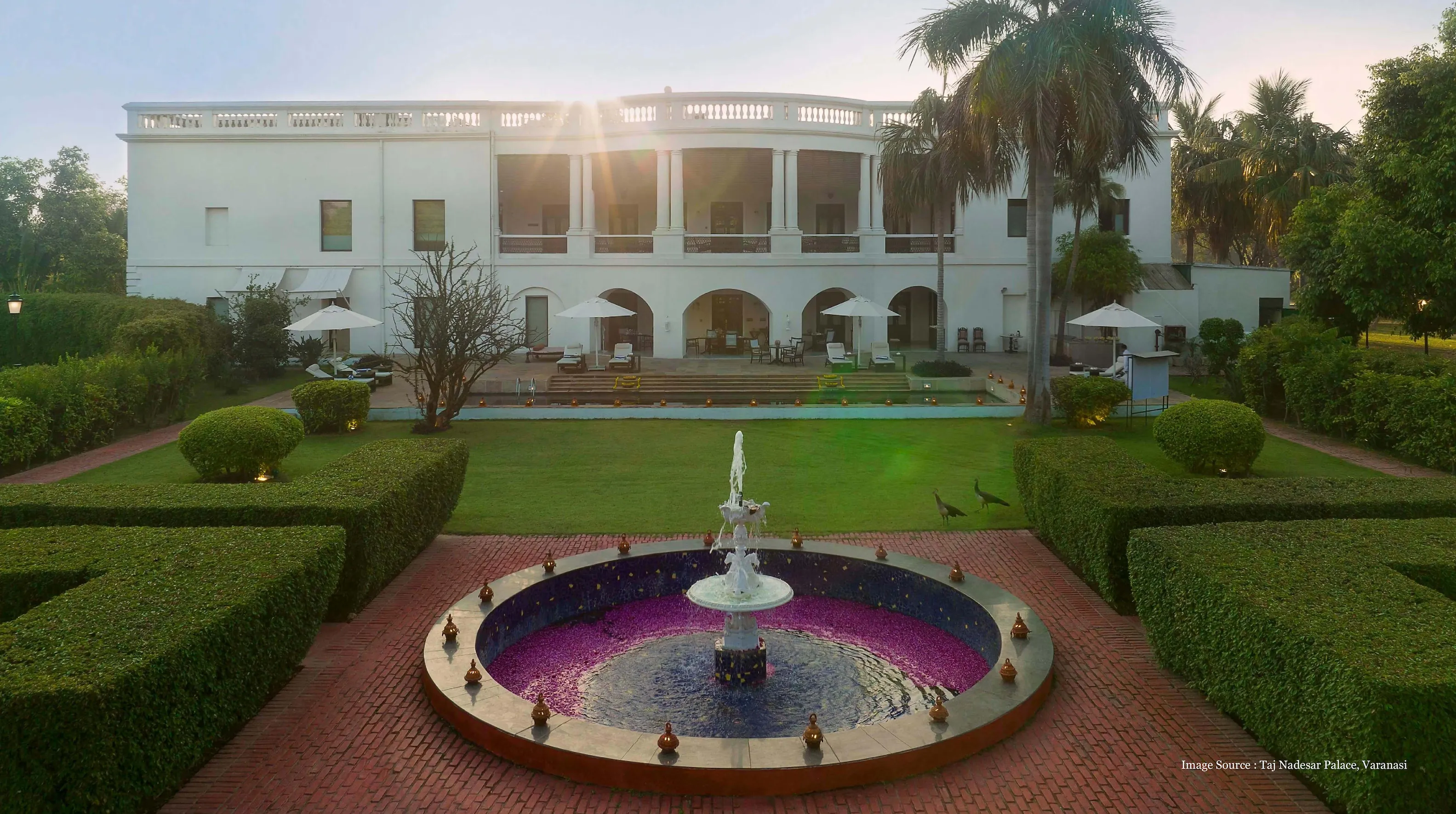 royal-palace-luxury-suites: Elegant palace garden with fountain and suites at Taj Nadesar Palace, Varanasi.