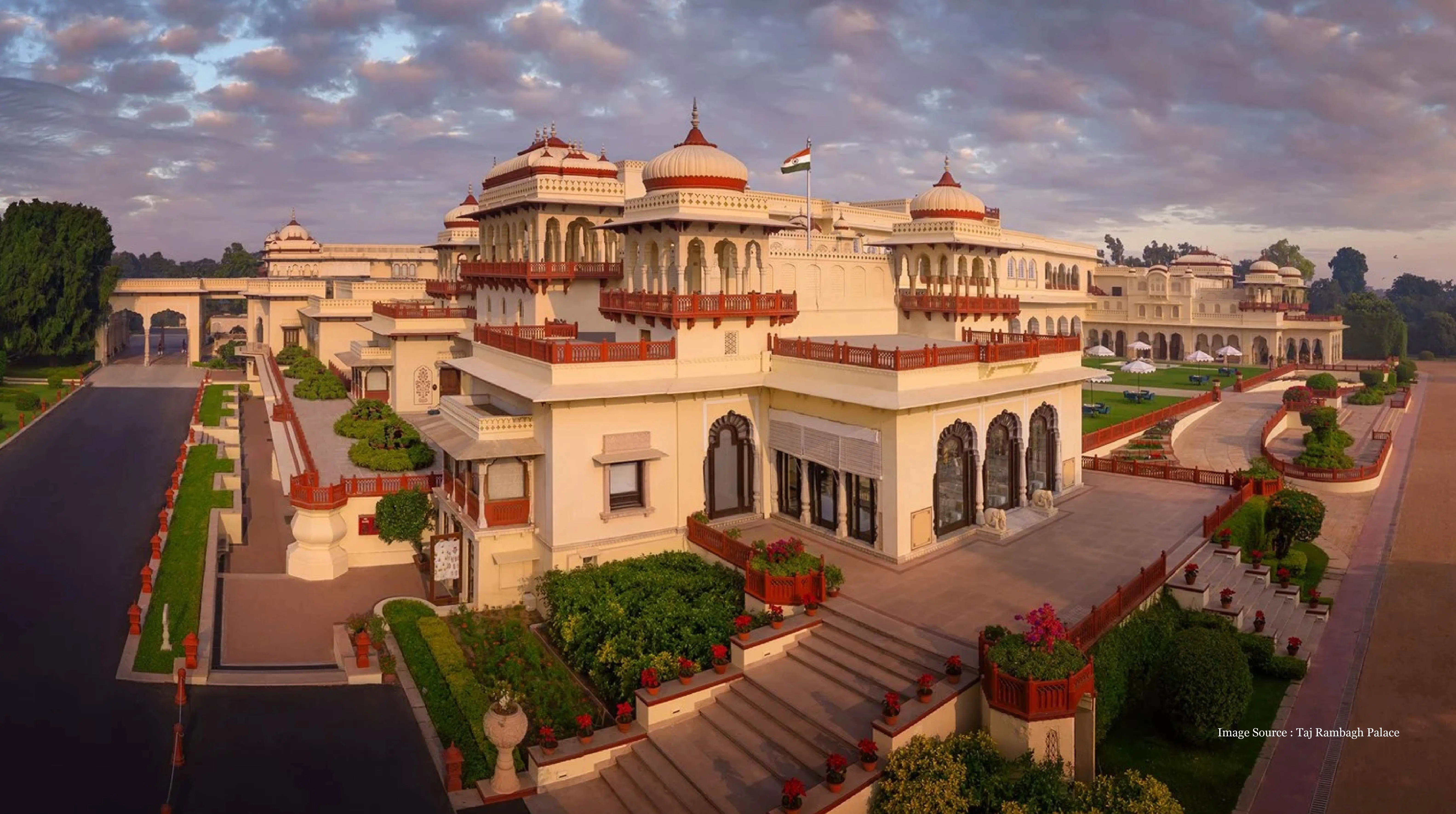 Luxury India travel packages featuring the opulent Taj Rambagh Palace in Jaipur, showcasing royal architecture, landscaped gardens, and elegant terrace views