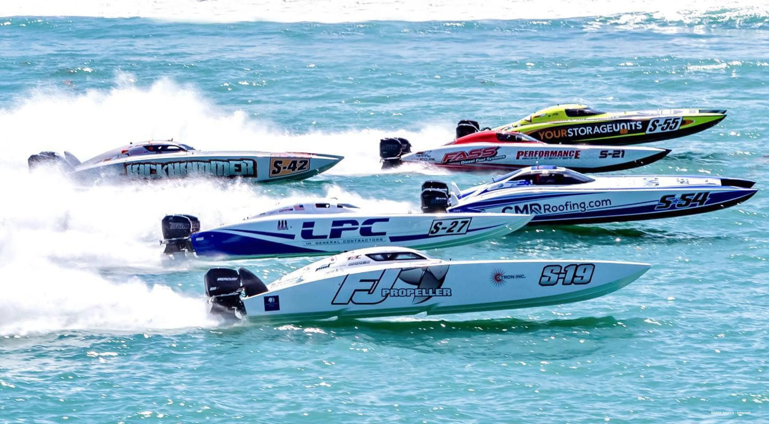 five colorful powerboats racing on water on a sunny day