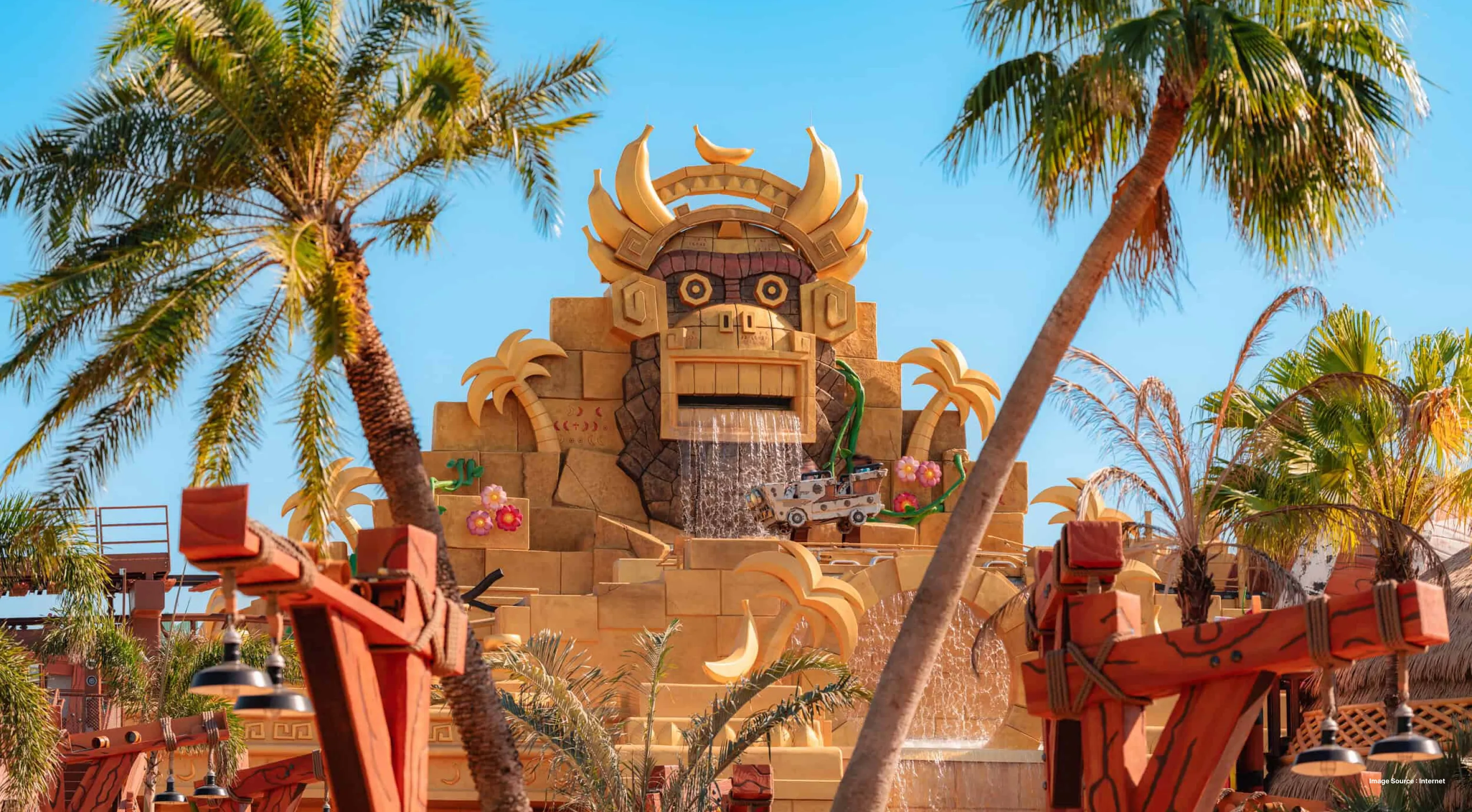 entrance of a children's ride with a yellow colored dragon character