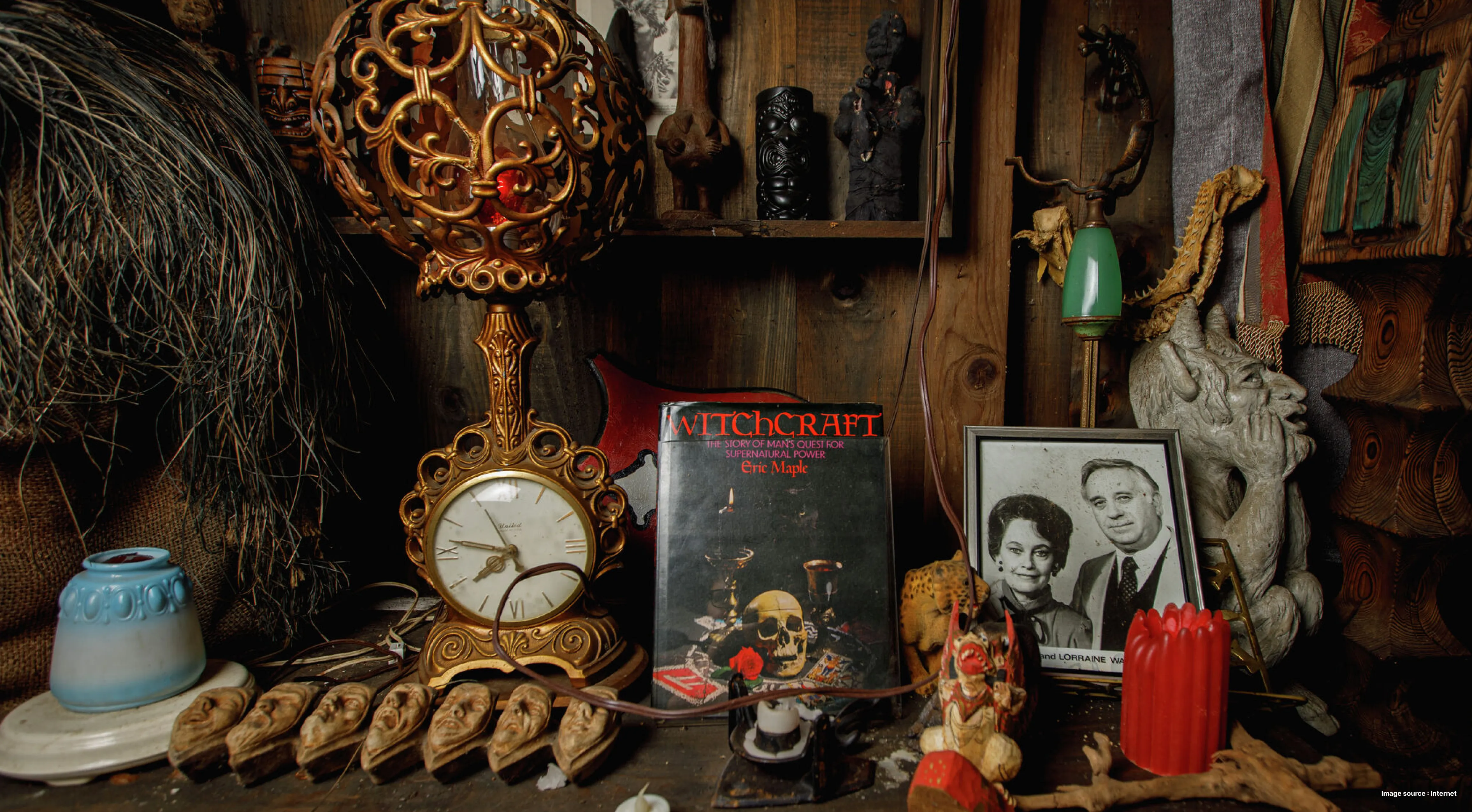 an eerie image of a collection of creepy items alongside a framed picture of the warren couple