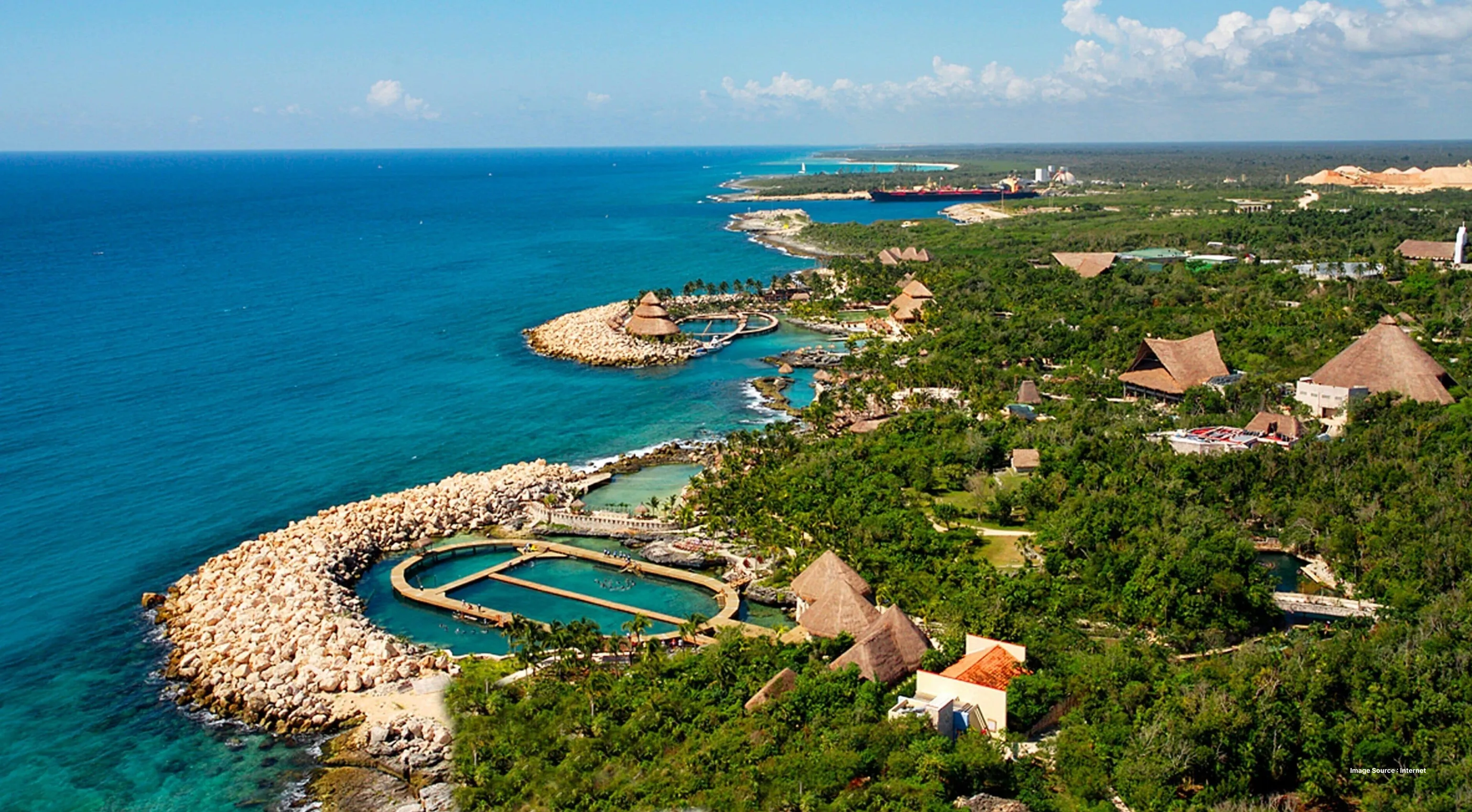 aerial shot of xcaret park in mexico with lush greenery and coast