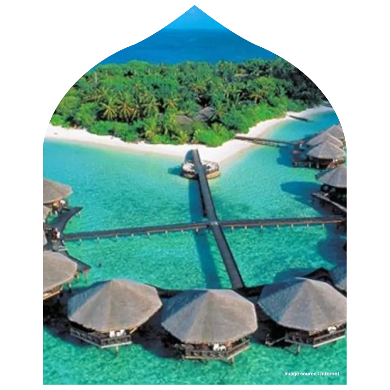 an aerial shot of grey roofed resort stays lined up on water in andaman