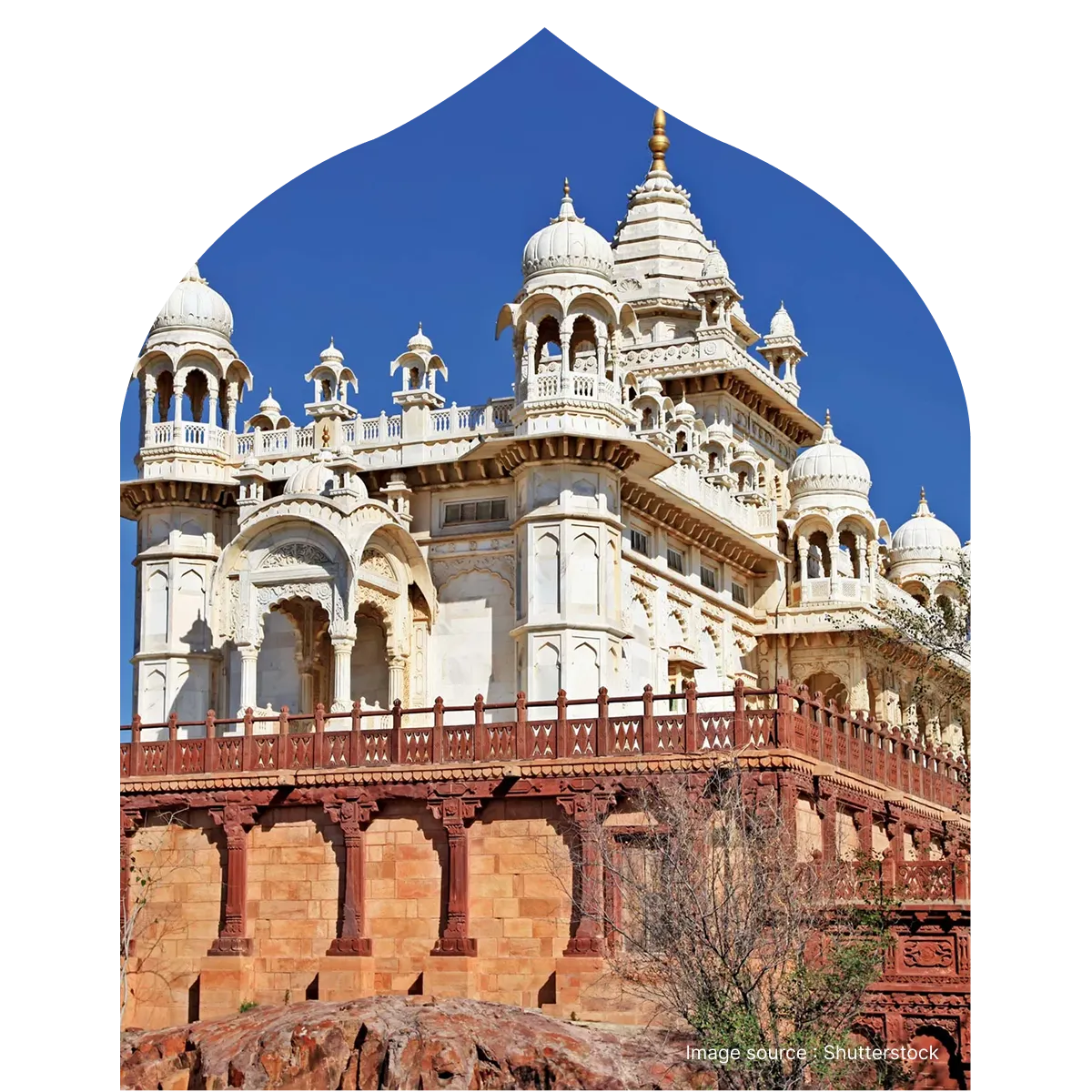 The intricate white marble domes and carved balconies of Jaswant Thada set against a vibrant blue sky.