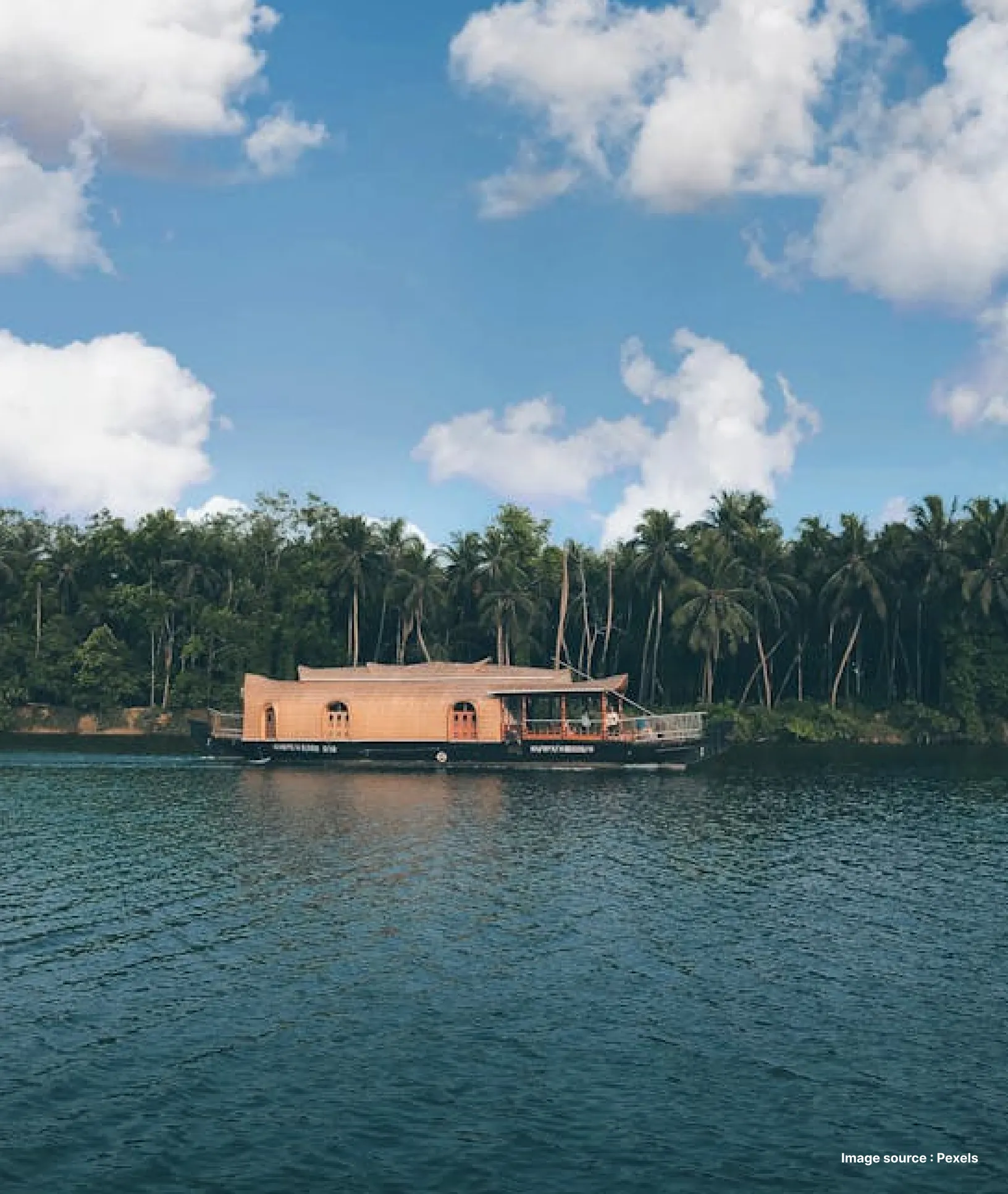 An Image of a luxury houseboat in the serene backwaters of Kerala