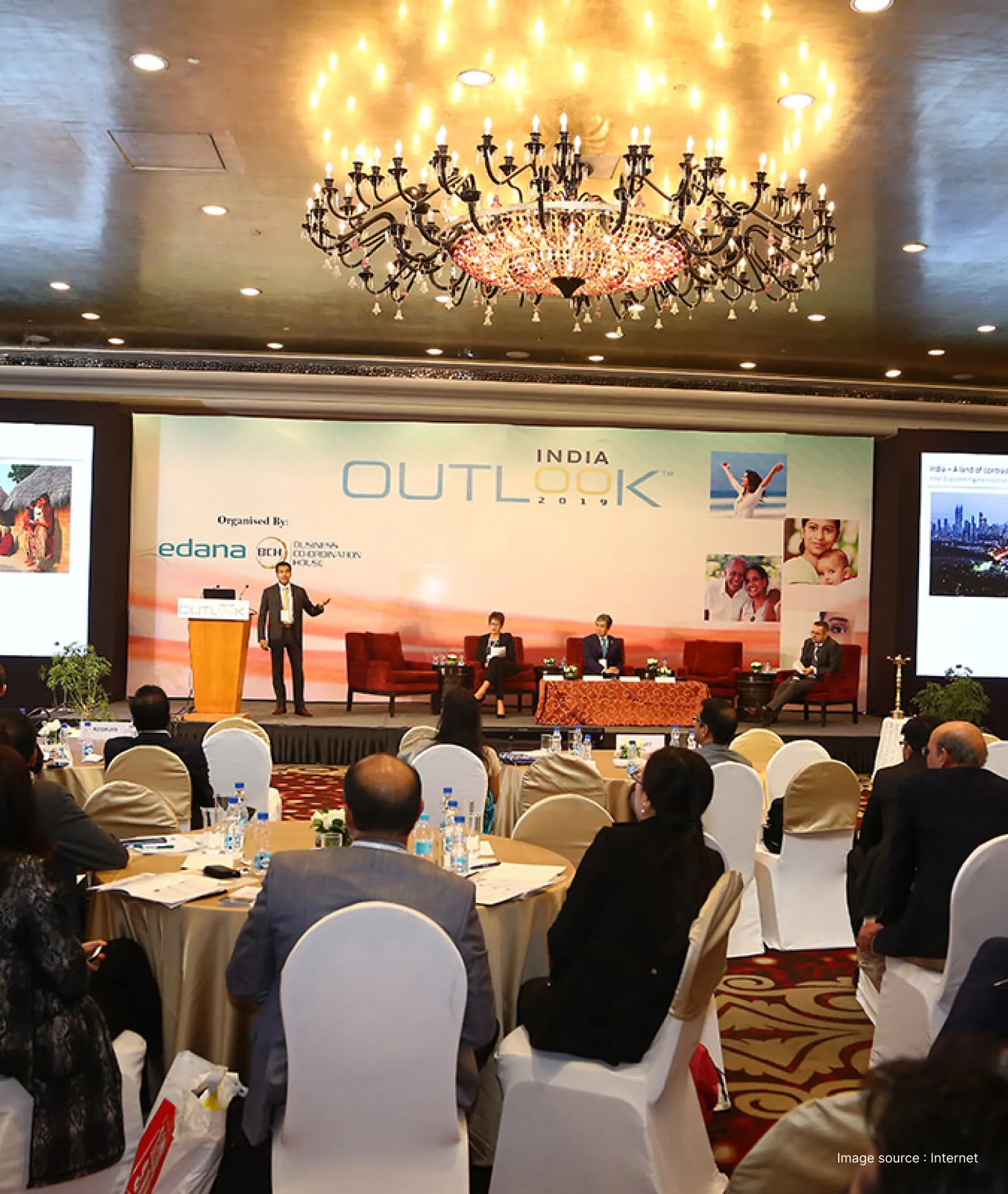 a business event ongoing as the speaker addresses the audience on stage