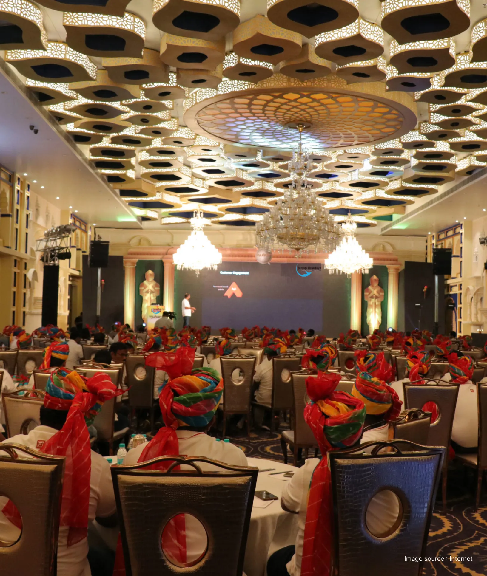 a corporate meeting going on with people wearing a traditional indian headgear