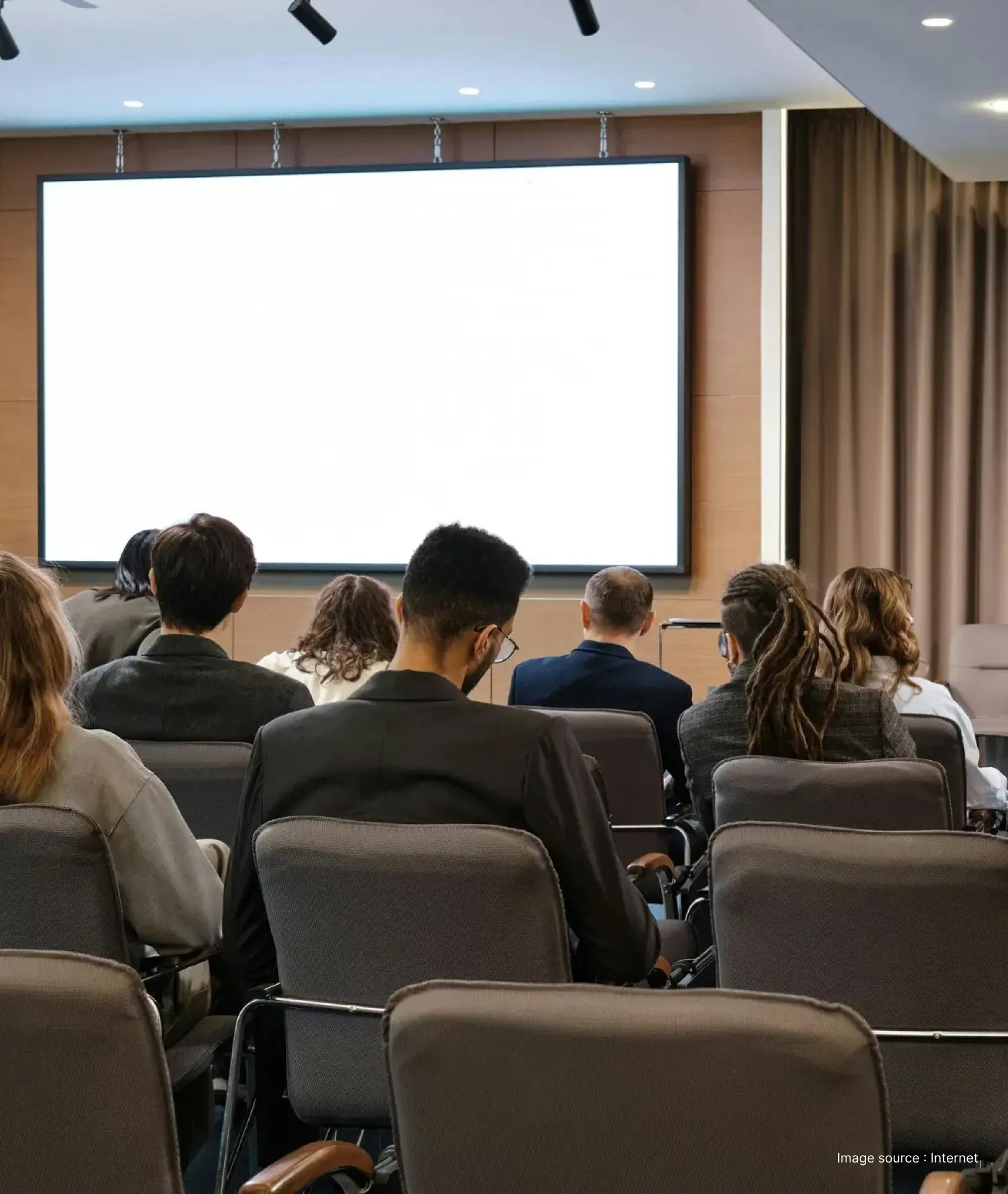 a business meeting ongoing with presentation with brown chairs