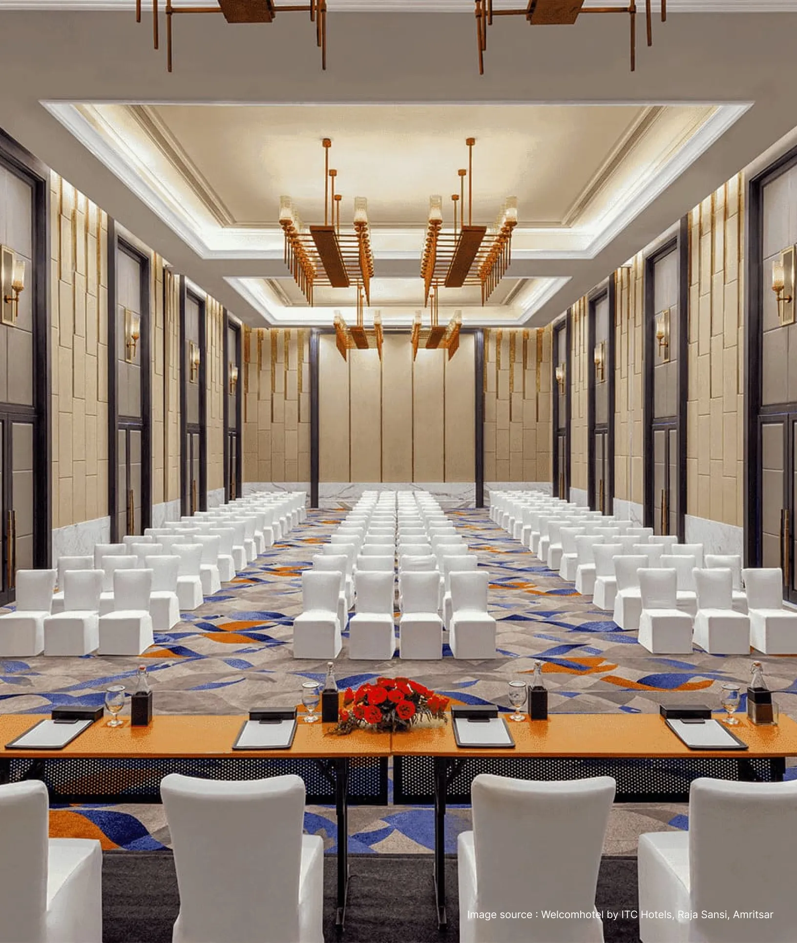 a conference hall with white chairs and a stage setup
