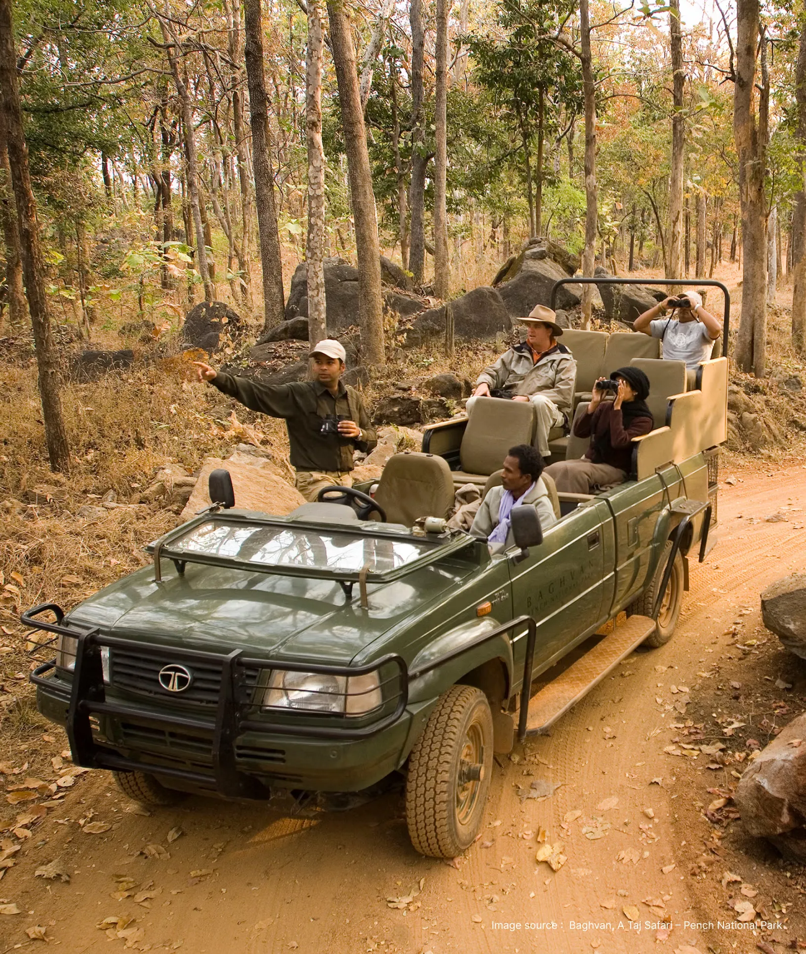 a naturalist guides a tourist group on a tiger safari in a jeep
