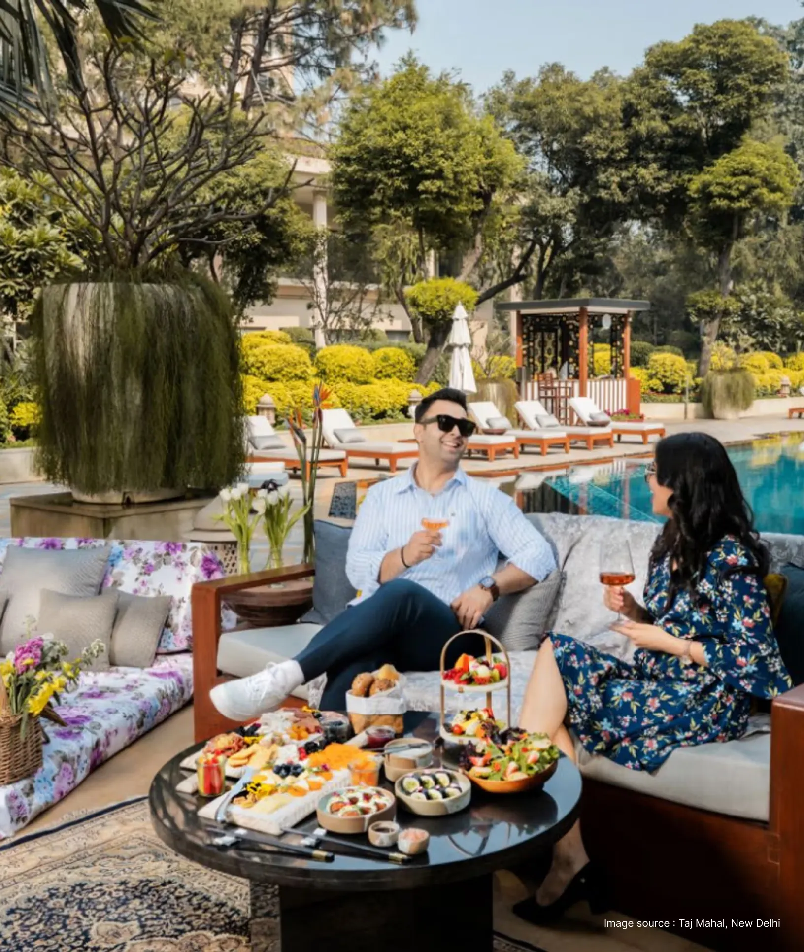 a couple enjoys a lavish brunch spread by the swimming pool
