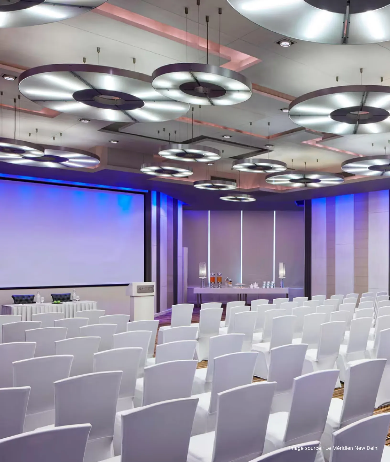 a conference hall with white chairs at le meridien