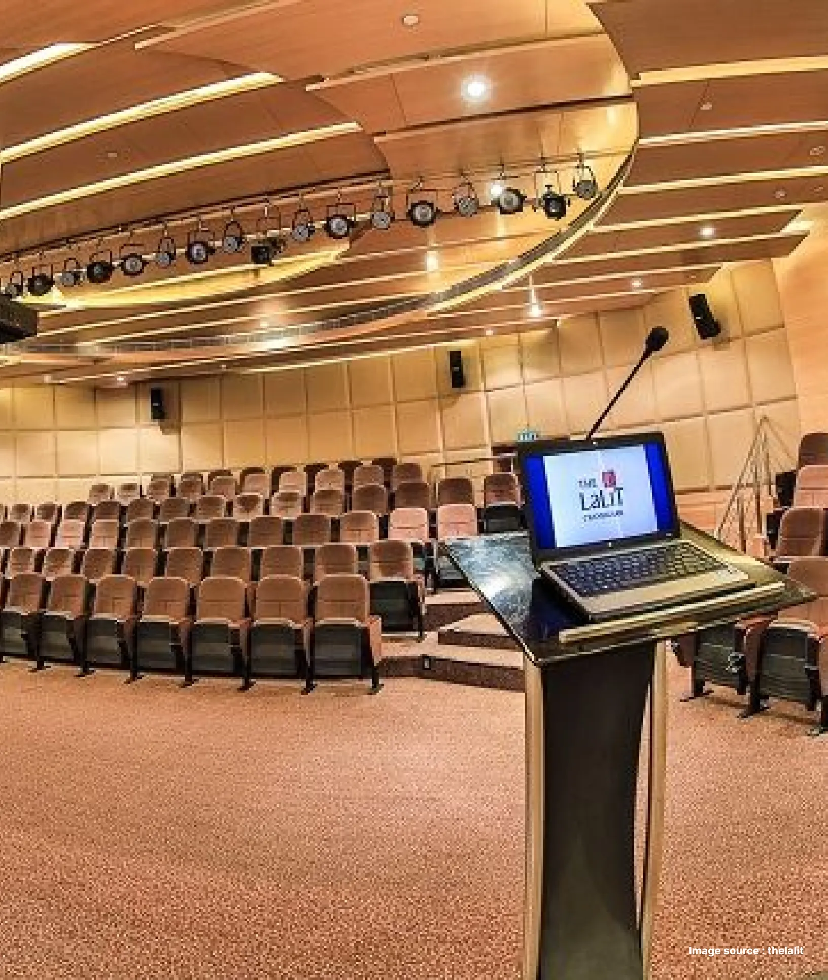 a conference venue at lalit hotel with brown chairs