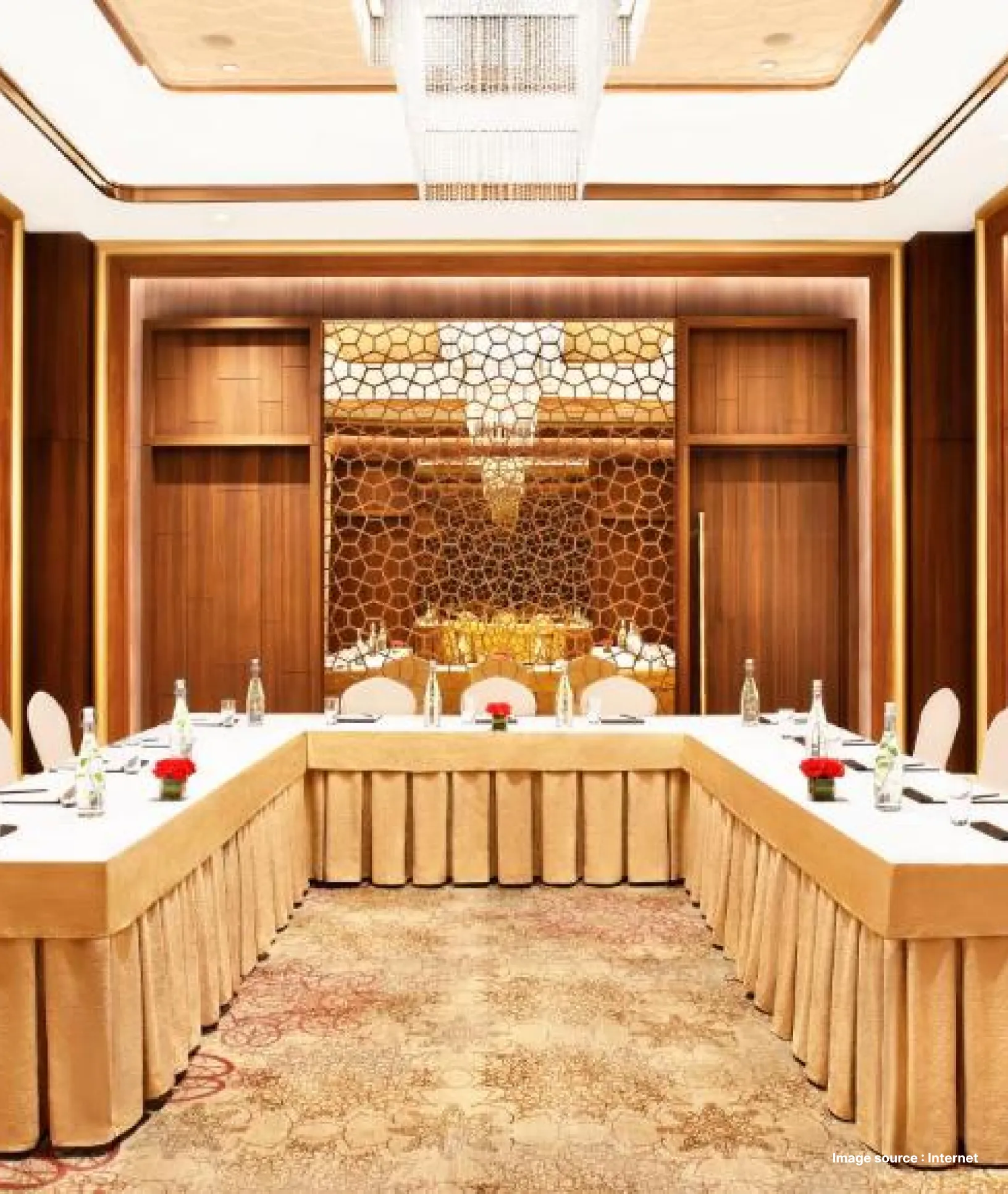 a meeting setup in a luxury hotel with golden chandelier and decoration