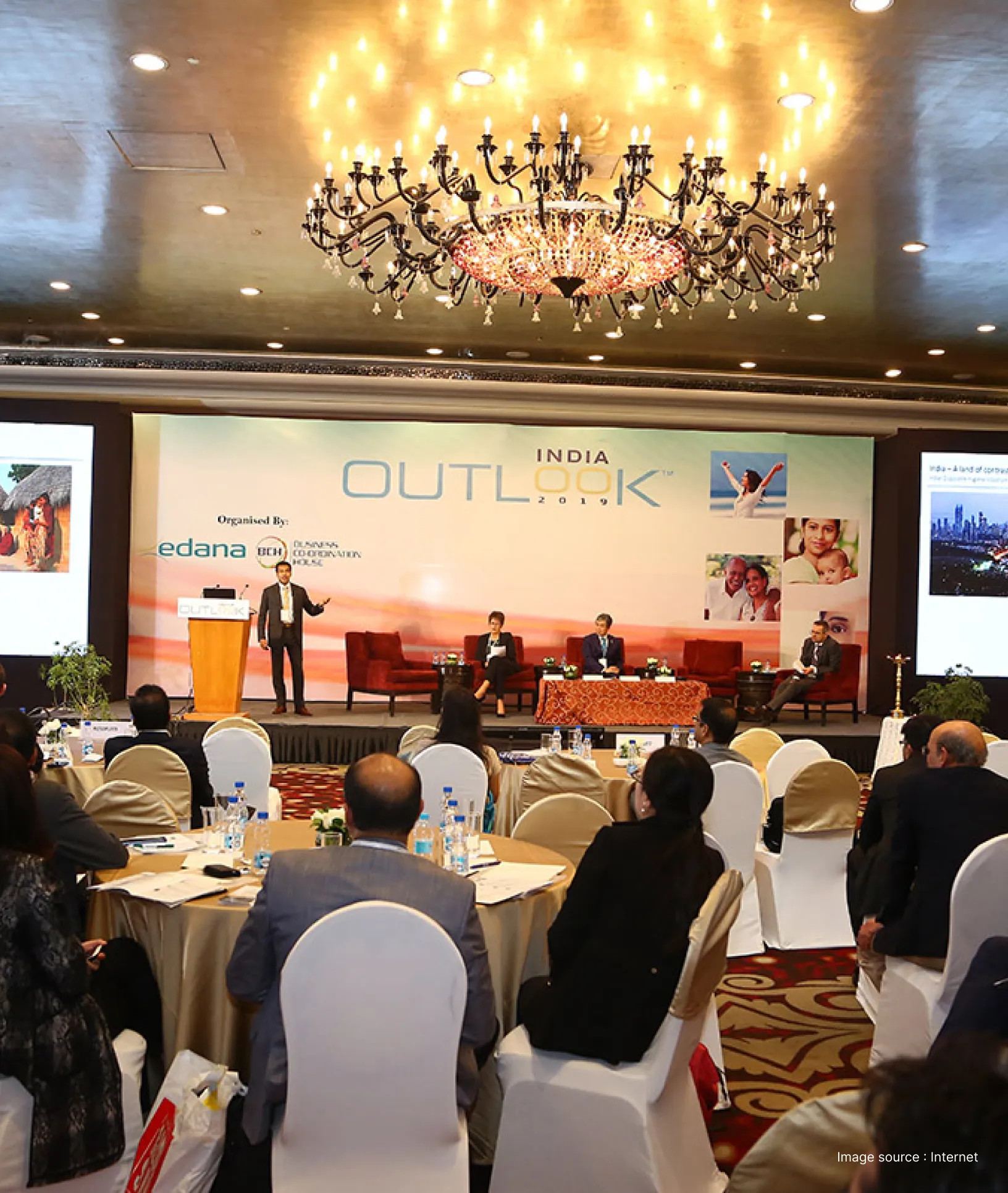 a corporate event going on with a golden chandelier