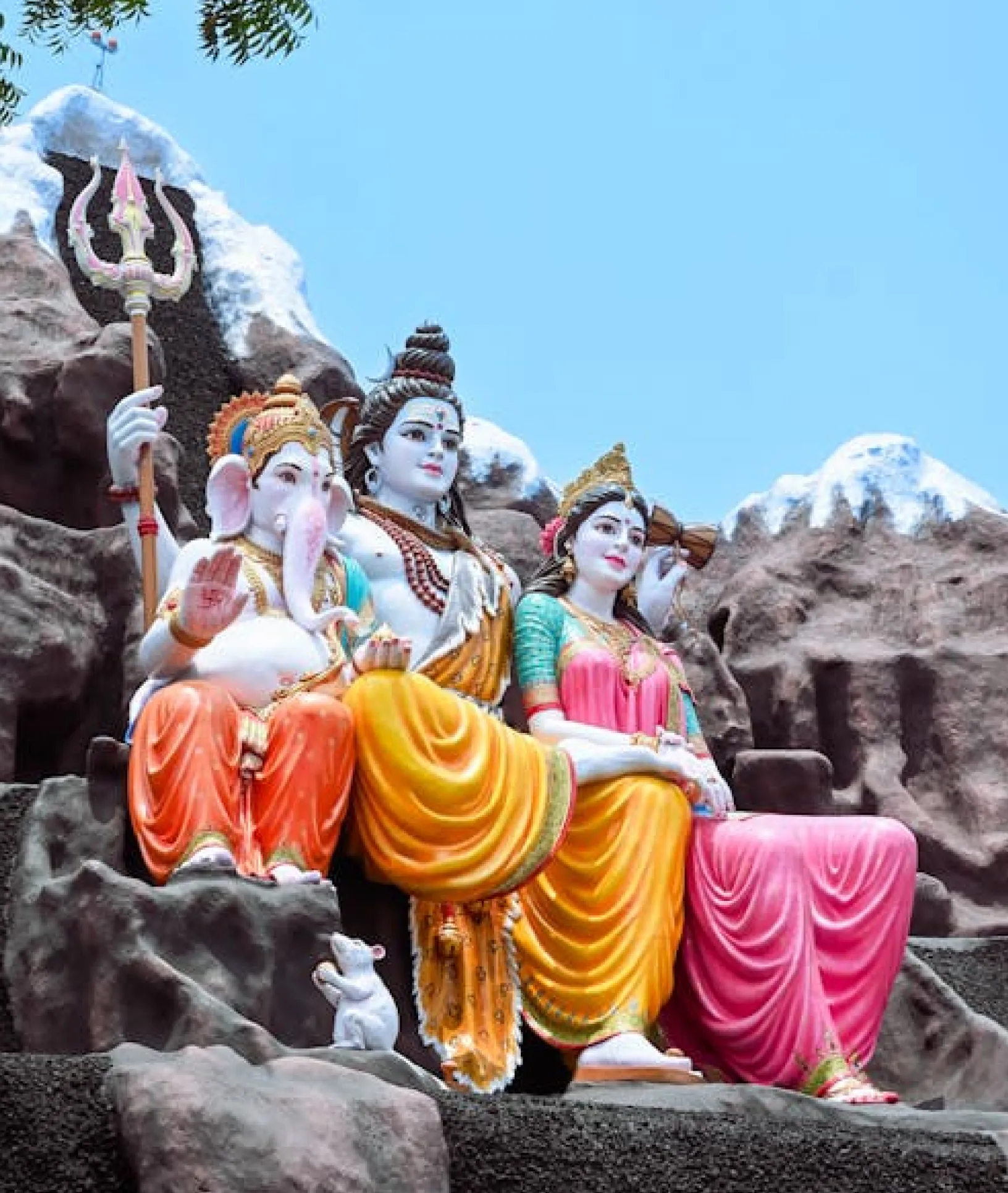 colorful hindu dieties idols with mountain views