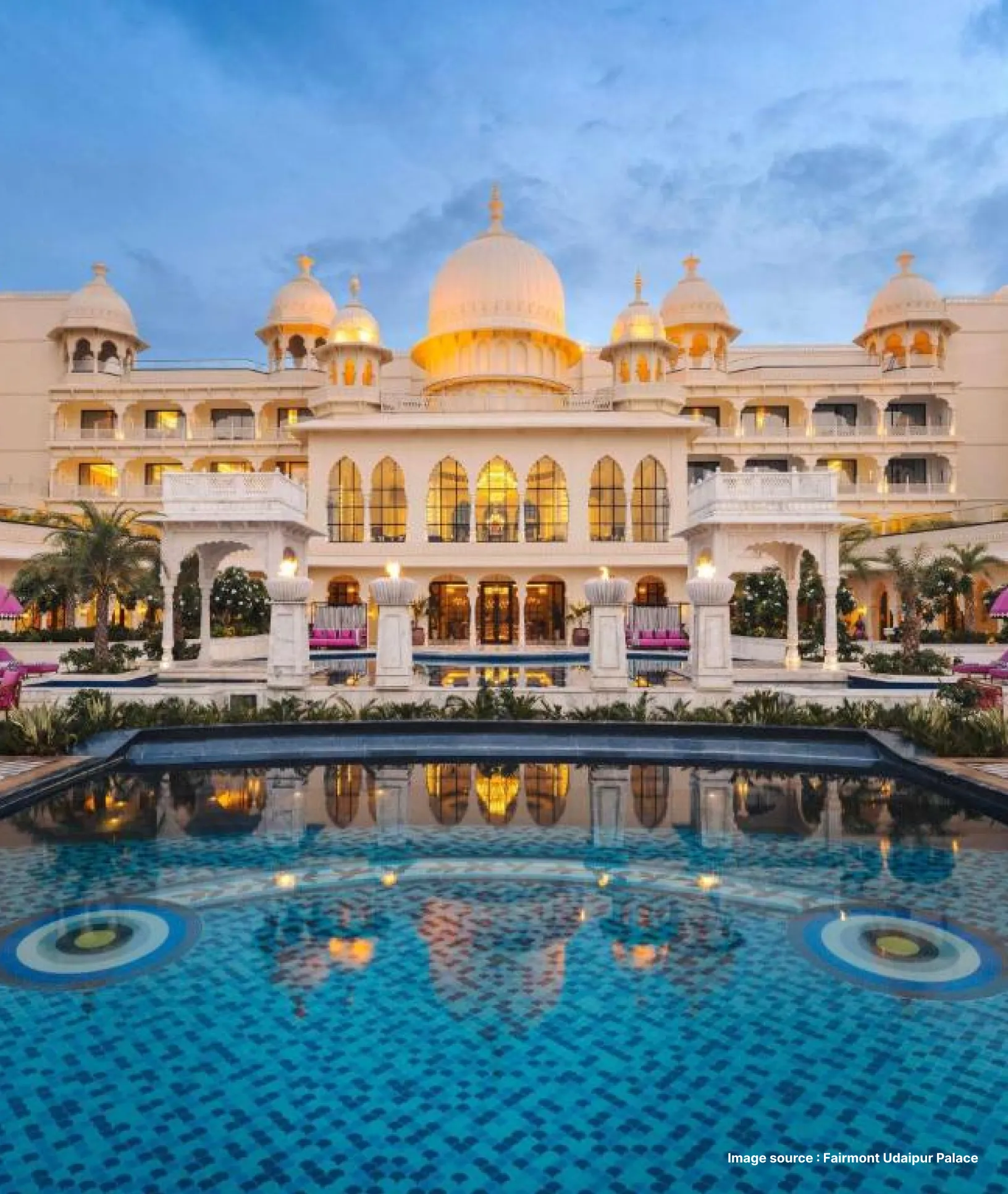 a front view with the pool area of the royal fairmont palace with domes