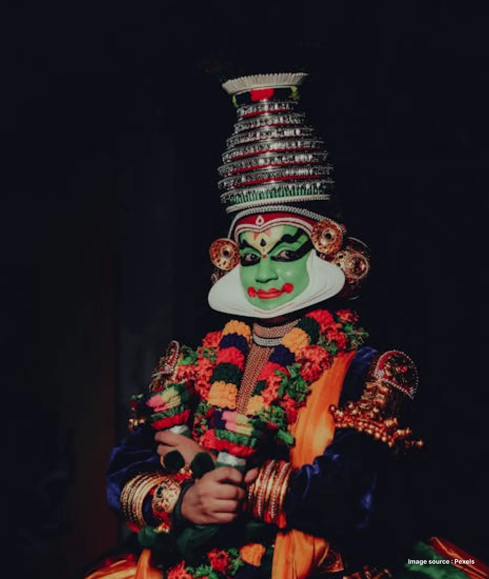 an elaborately dressed kathakali dancer in india