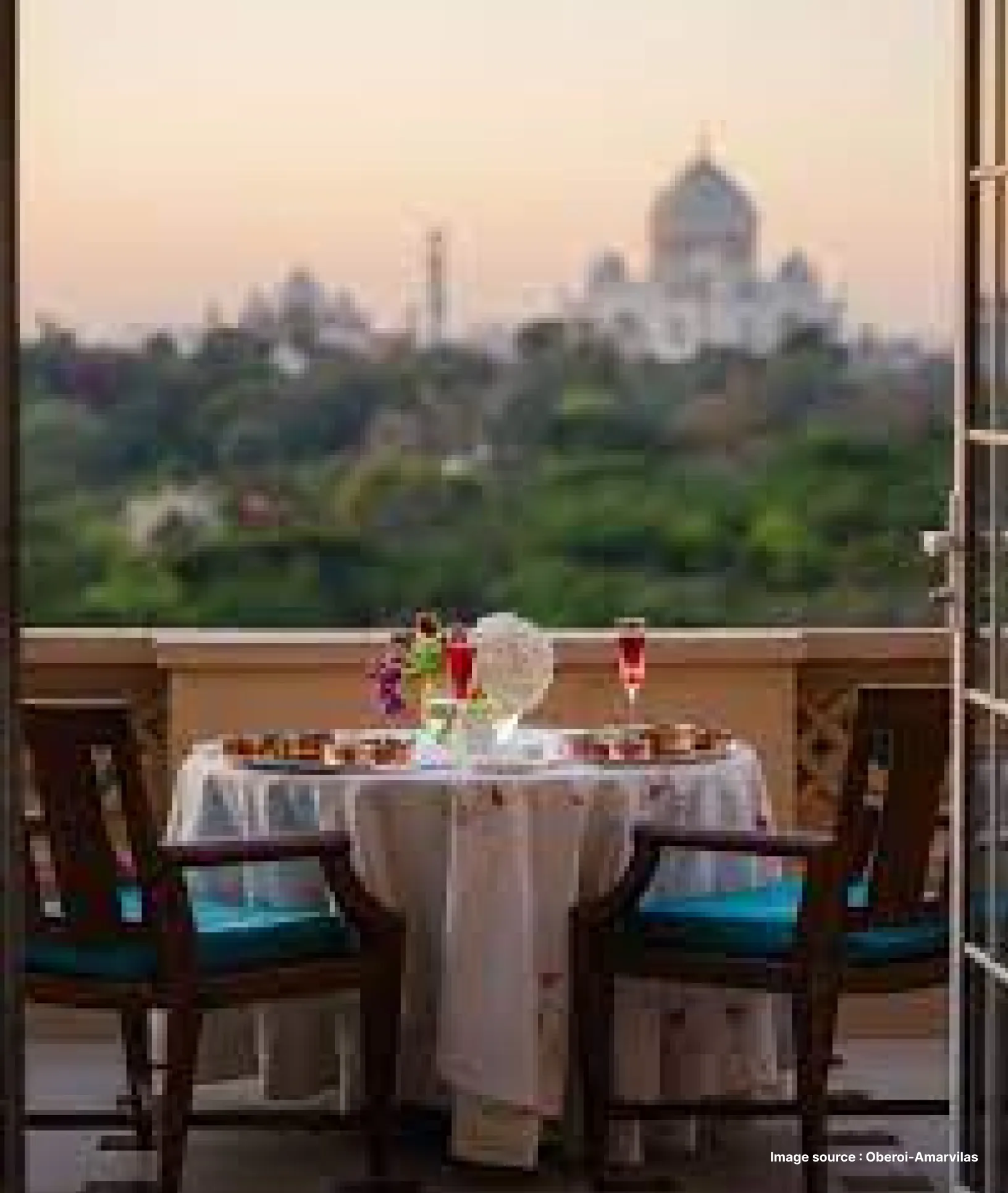 a luxurious dinner setup with taj mahal in view at the oberoi amarvilas