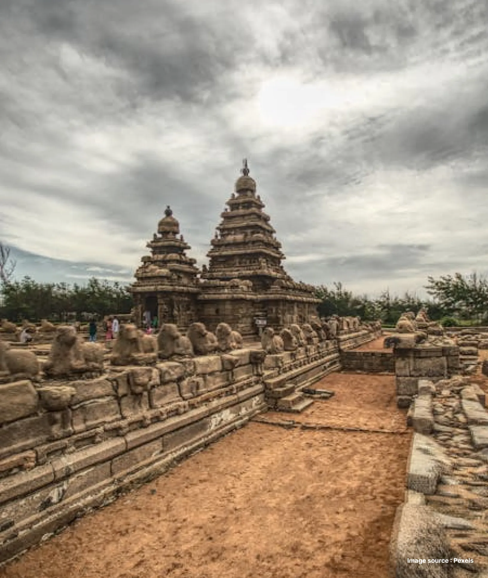 temple structures on the coast of mahabalipuram with cloudy skies
