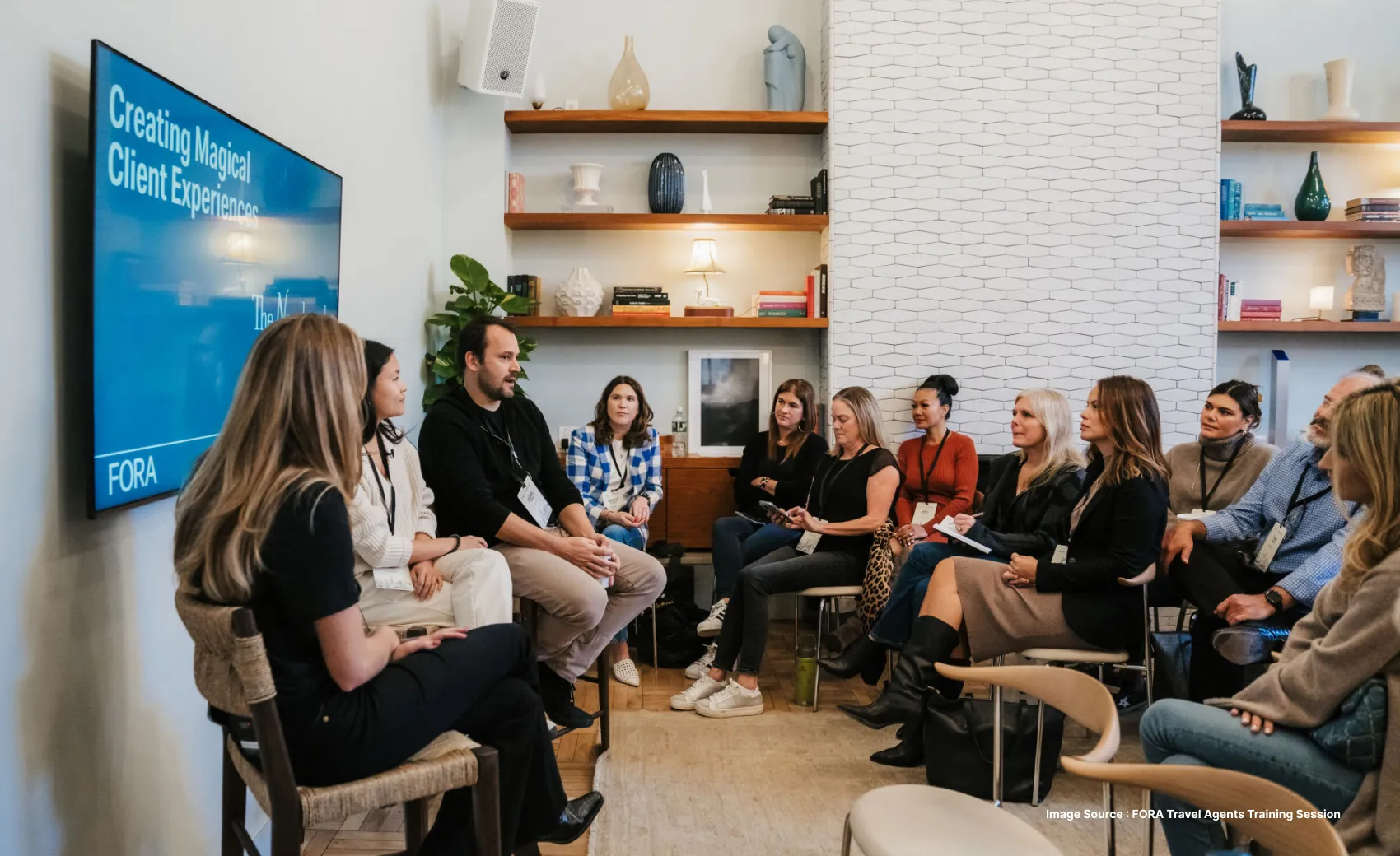 fora travel agency taking a training session for travel agents with a presentation open on the television