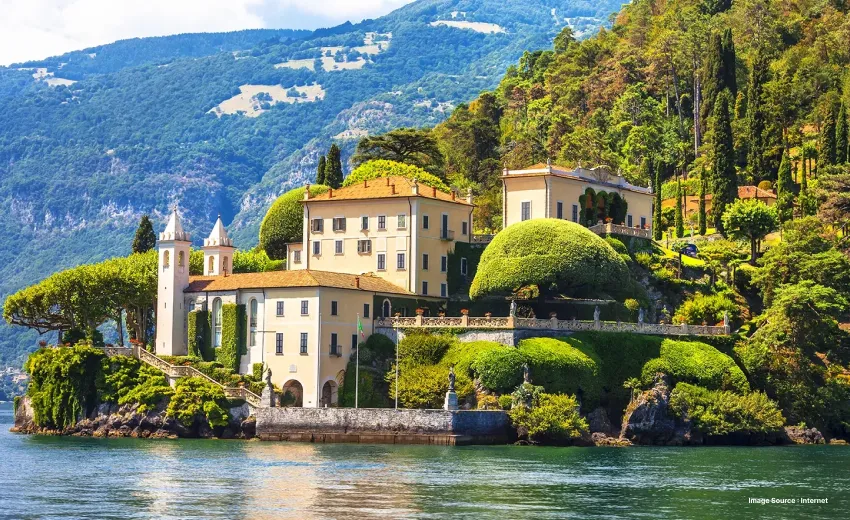 a gorgeous view from lake como of a fancy looking cottage