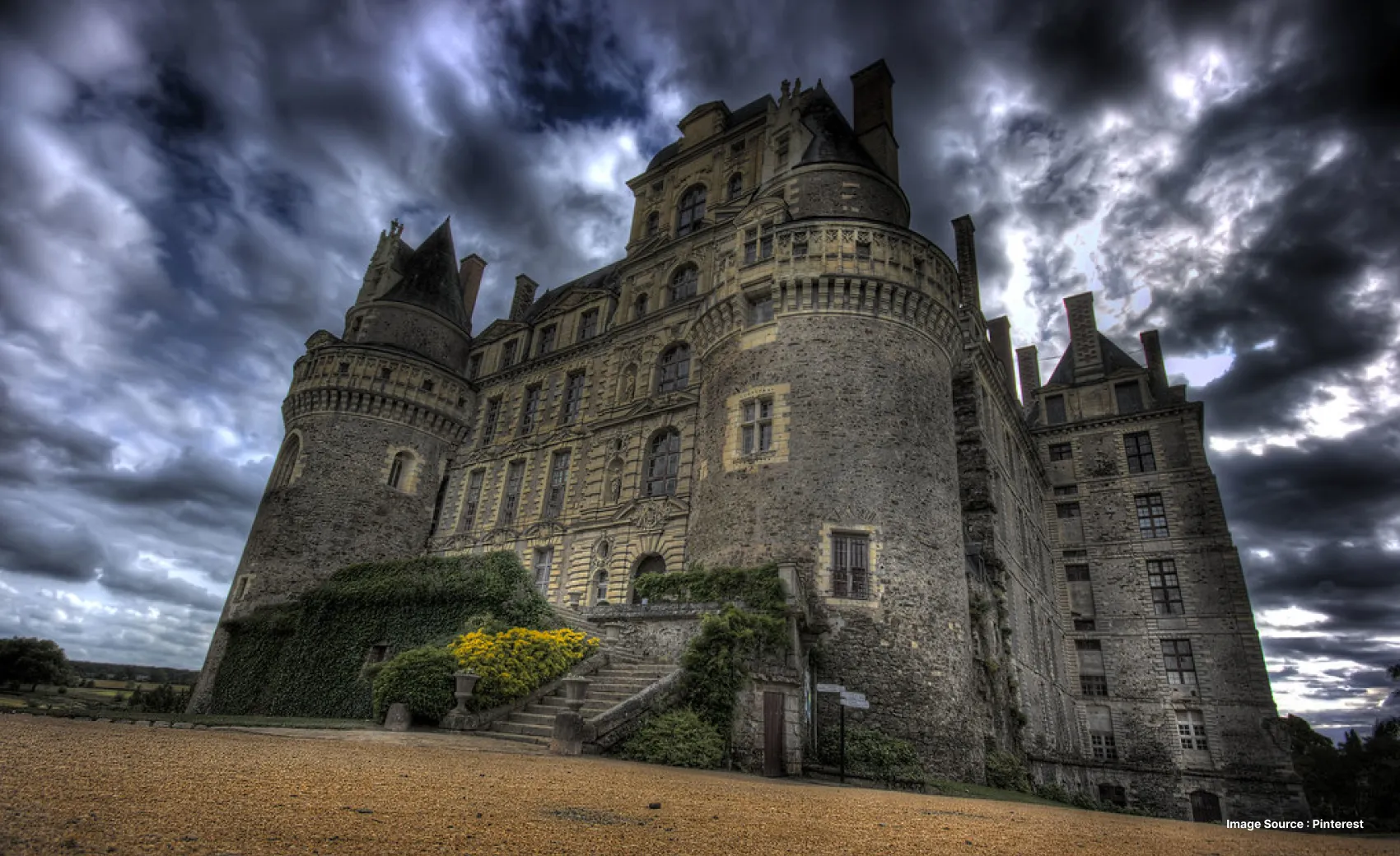 an ancient castle with a dark cloudy sky, with a staircase entrance