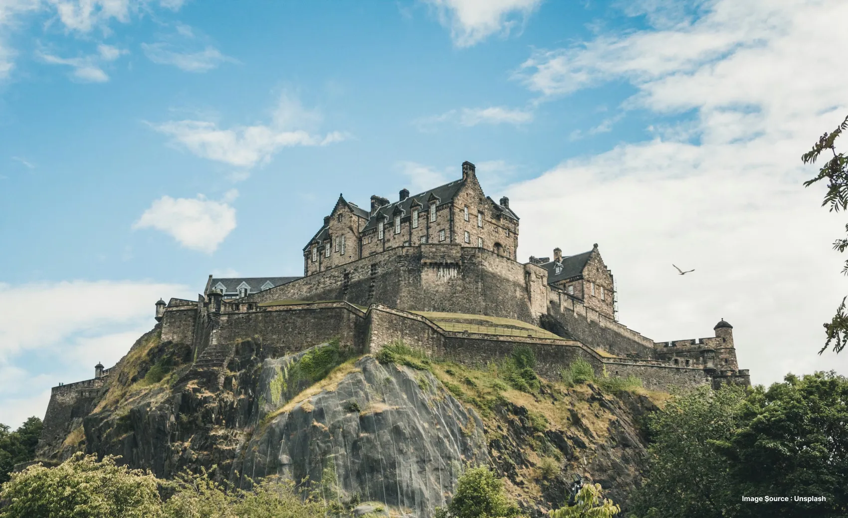 a rugged hilltop castle with old walls on a clear sunny day