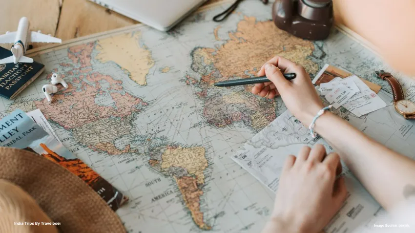 a picture of someone using a pen on a map and pointing to something on the map
