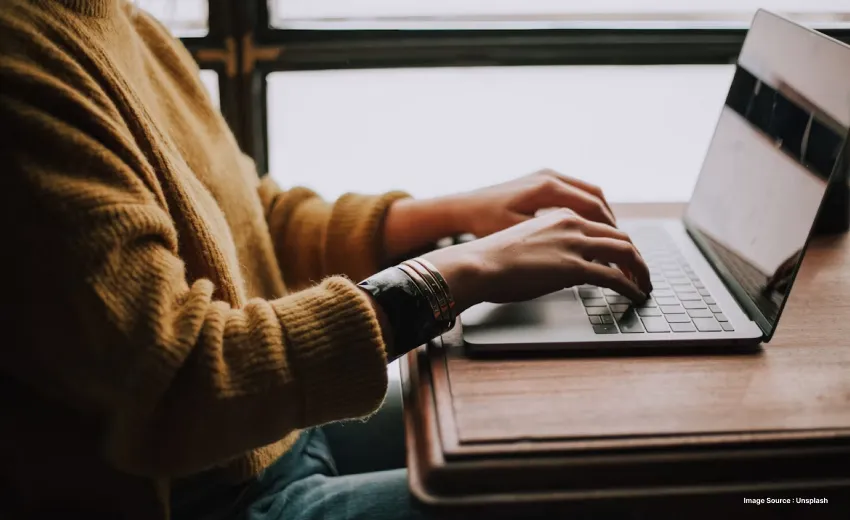 Someone typing on a laptop