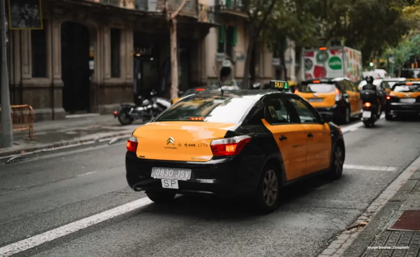 a yellow taxi in waiting on a street in Europe