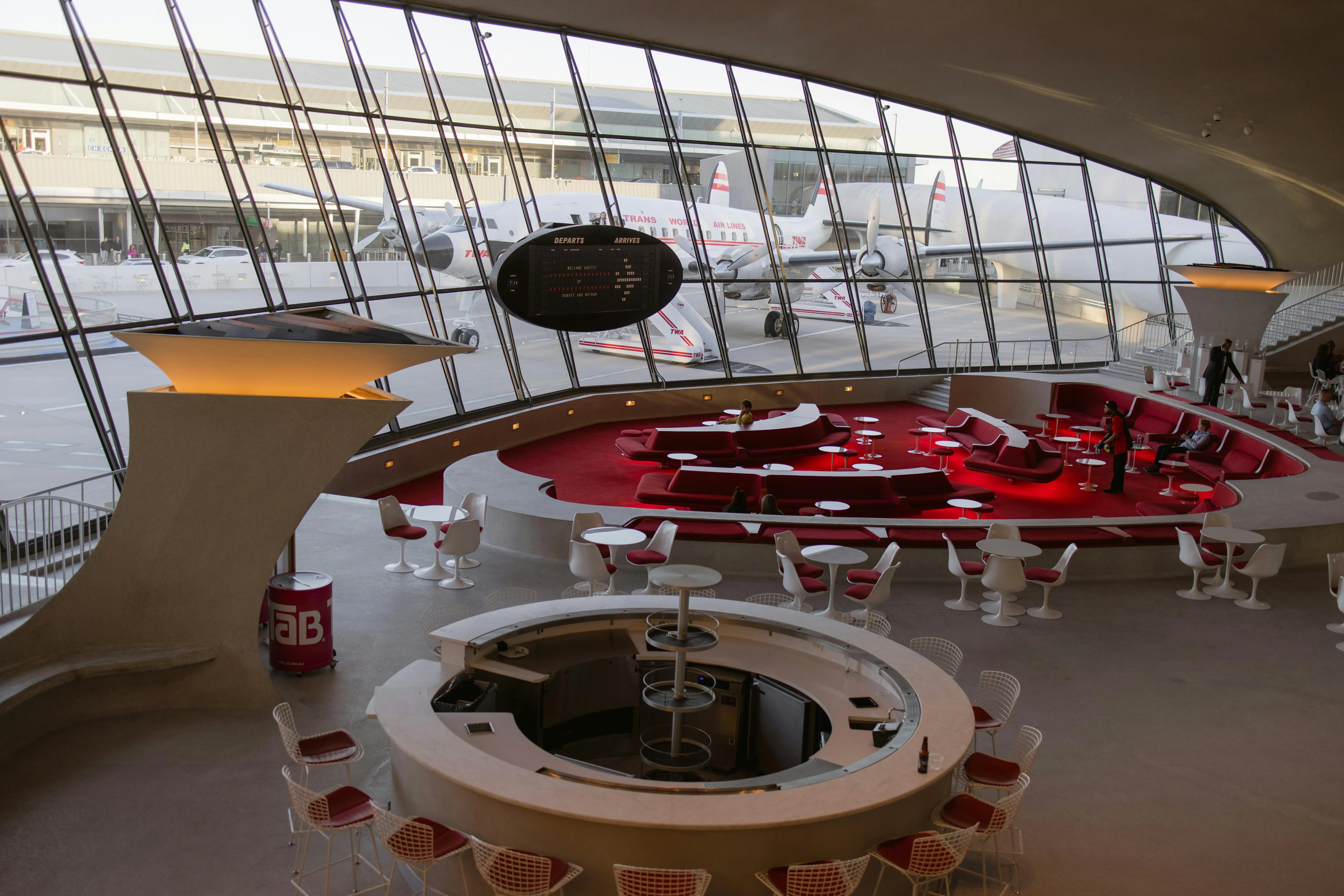 a view of a luxury airport lounge with red and grey interiors