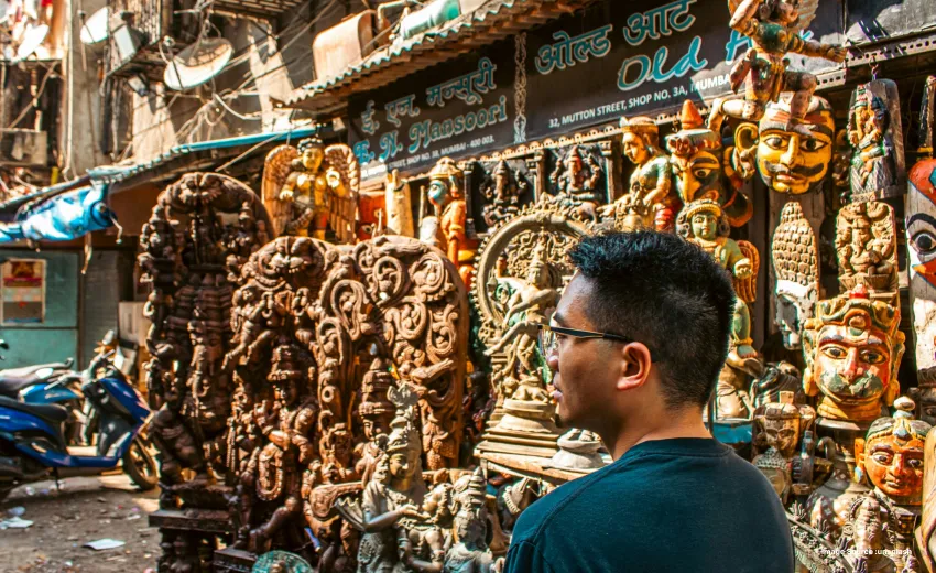 Traveler exploring a vibrant street market with traditional handicrafts