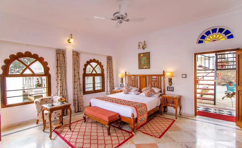 Elegant heritage bedroom with arched windows and classic decor