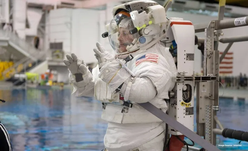 an astronaut dressed up with full equipment and cylinder on back