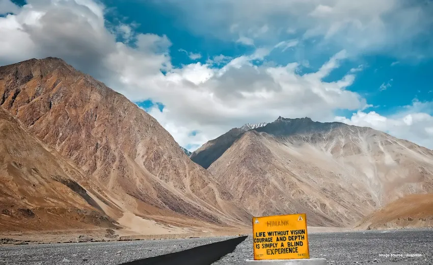 otherworldly landscapes of ladakh with two rugged hills and cloudy sky