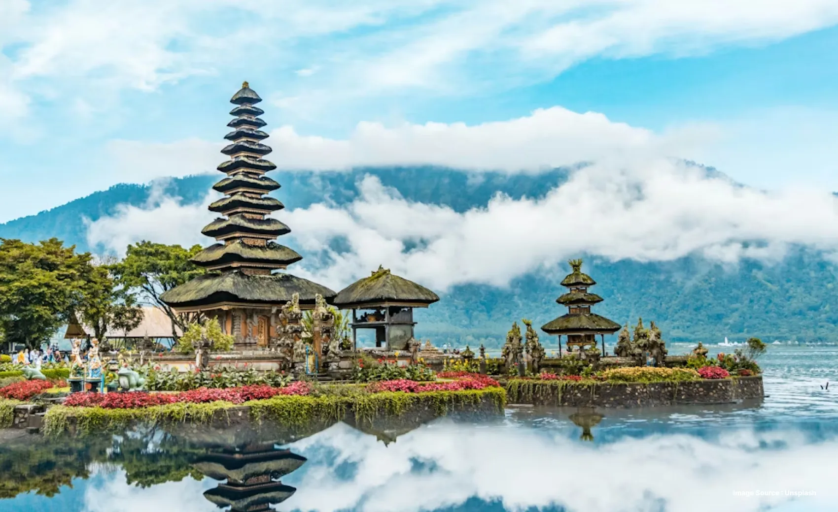 A Japanese temple with mystical clouds and a mountain in the back