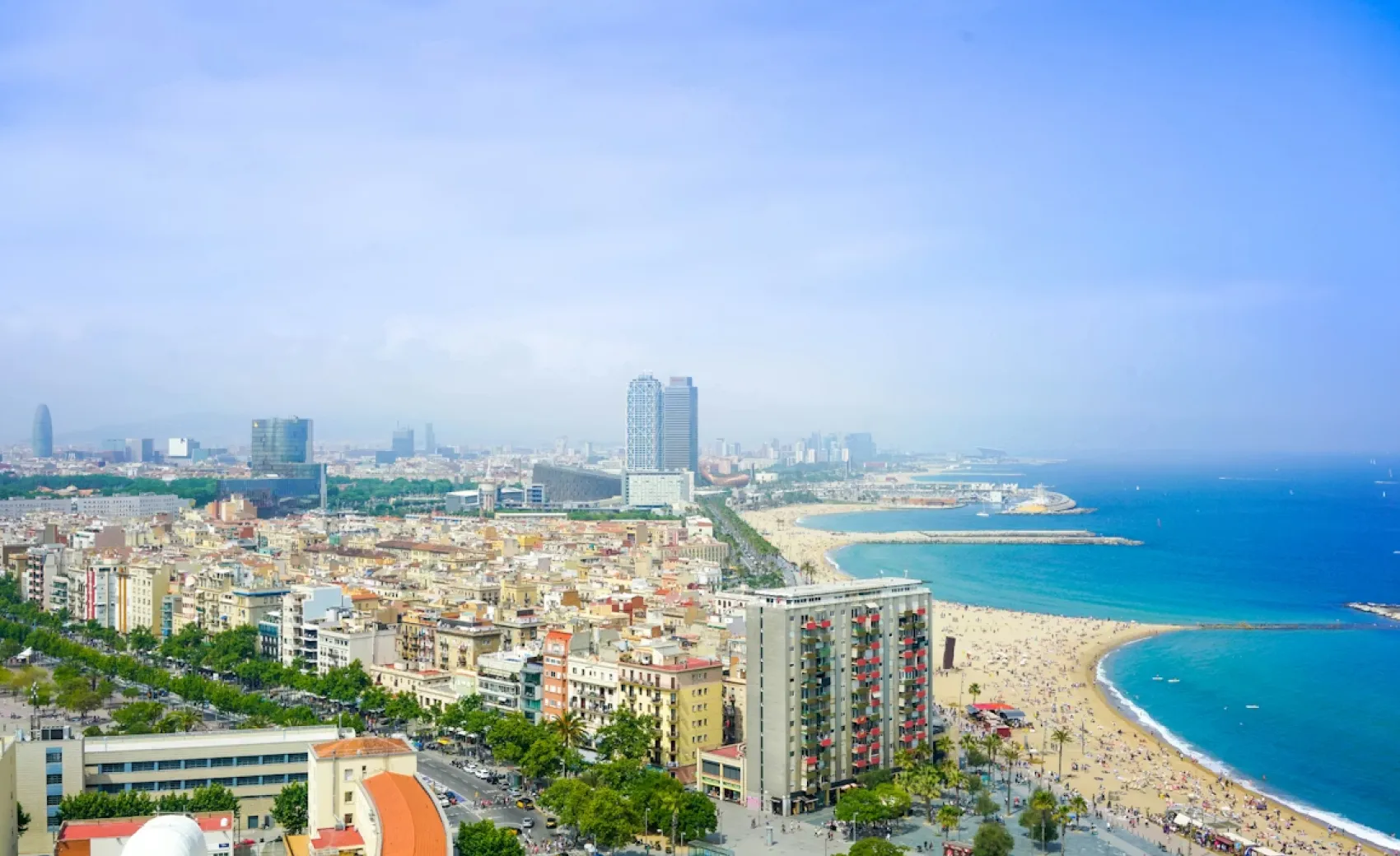 an aerial view of barcelona's skyline with the beach and populated city's buildings in view