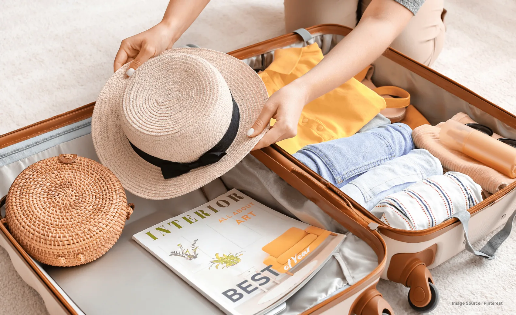 packing a suitcase with beach essentials such as a hat