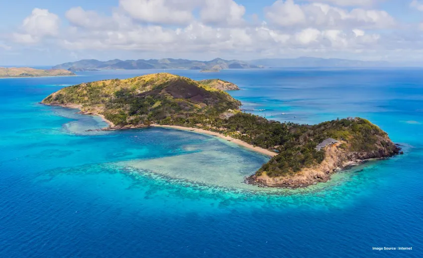 an aerial shot of fiji islands with green hills