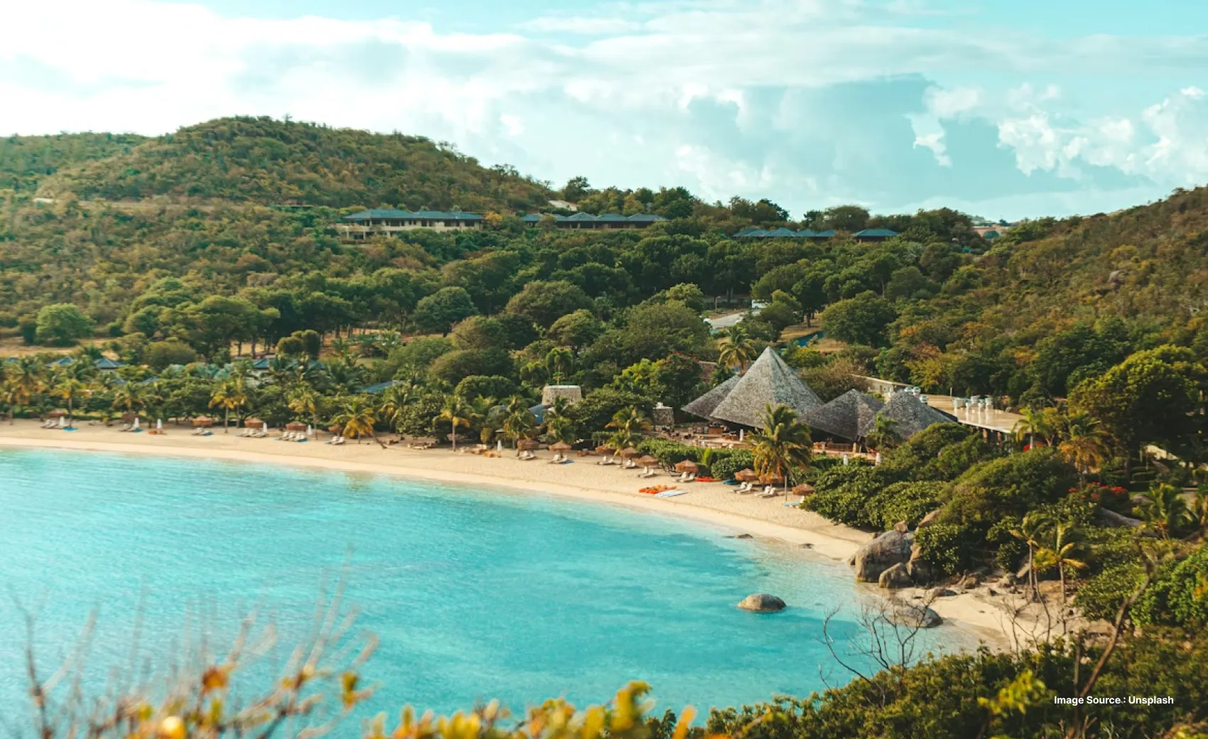 sunny day shot of british virgin islands with lounge chairs on the beach