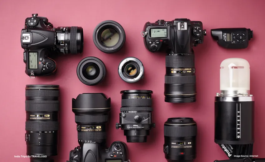 an image of a row of cameras and camera accessories against a red backdrop
