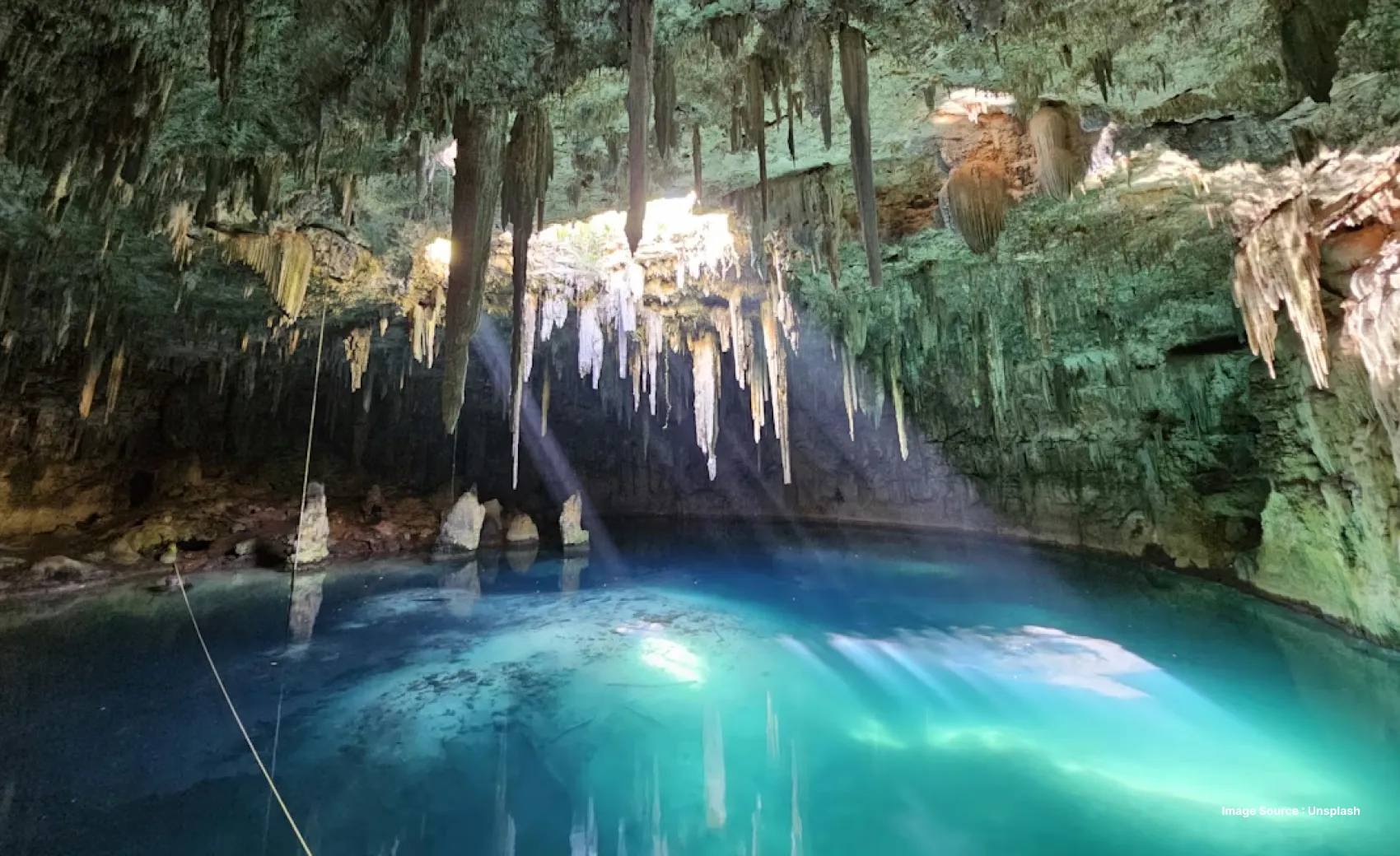 a mystical shot with iceicles as sunlight shines through in a cave
