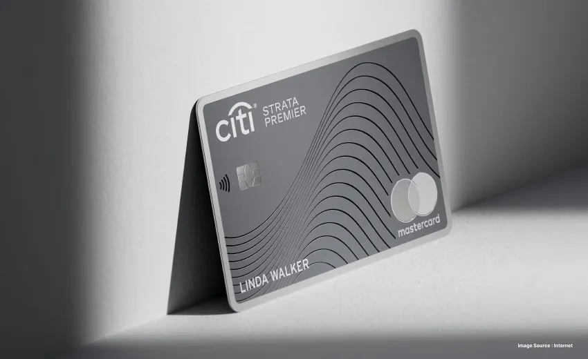 a grey citi strada premium card in light with a curvy pattern