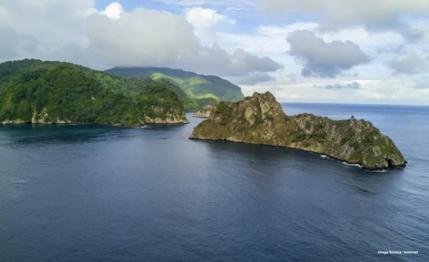 aerial shot of three green hill islands surrounded by stretching vistas of blue waters