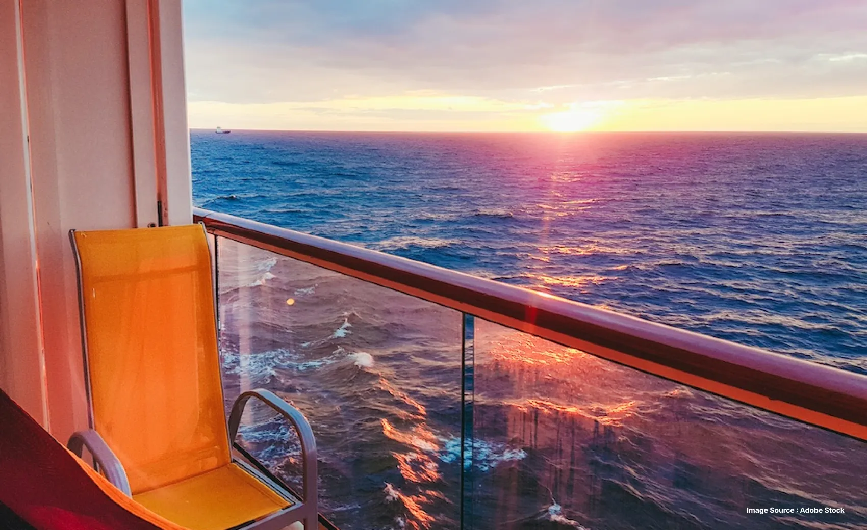 balcony sunset view from a cabin in a cruise with a yellow lounge chair