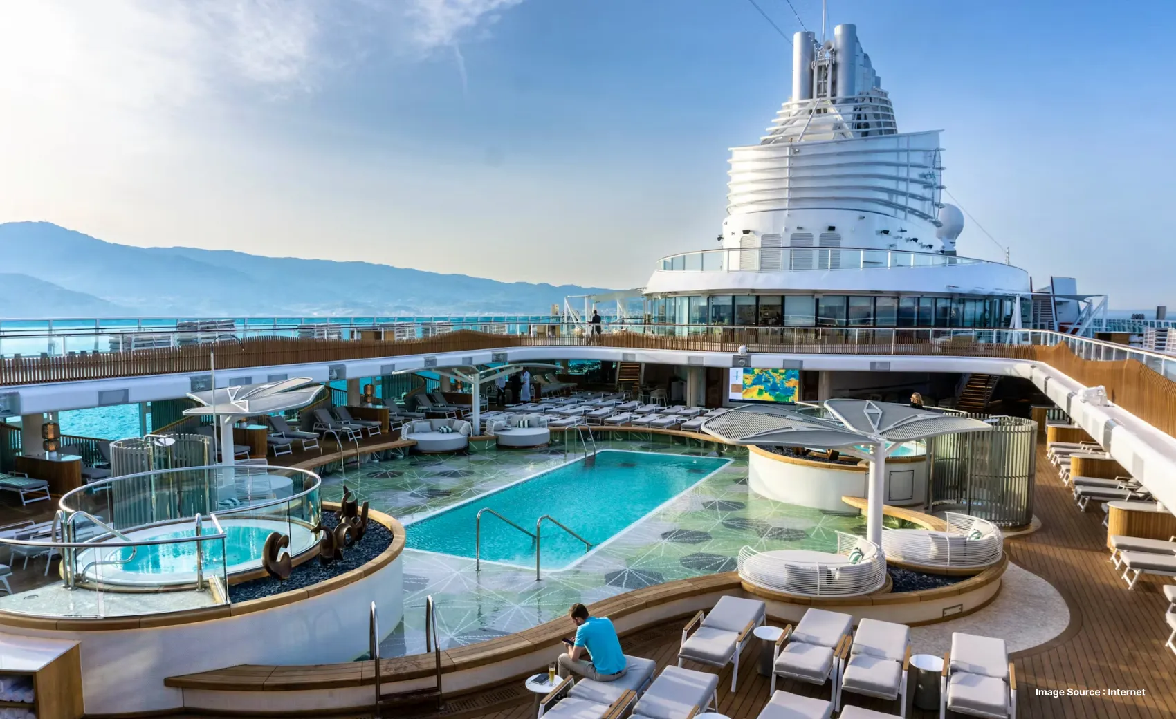 the open area on a ship with a pool and multiple viewing points and lounge seats