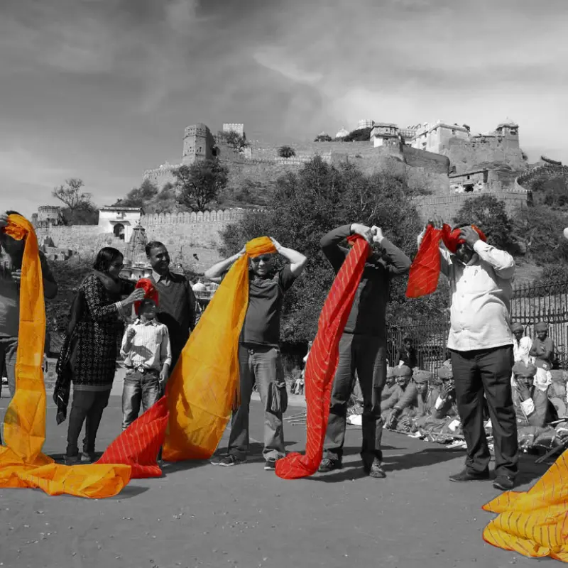 Group of People tring to wear colorful Rajasthani turban