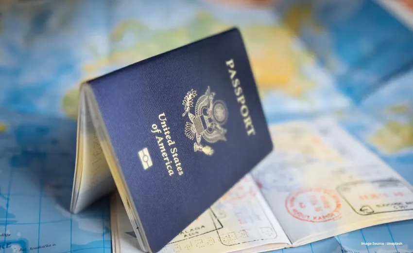 an image of a passport standing half open on a map on top of another passport