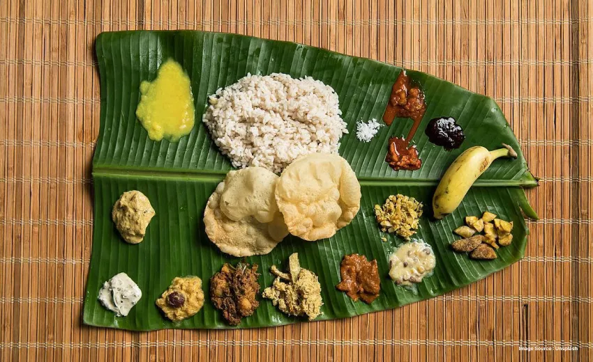 a south indian feast served on a banana leaf with rice, papadam etc.
